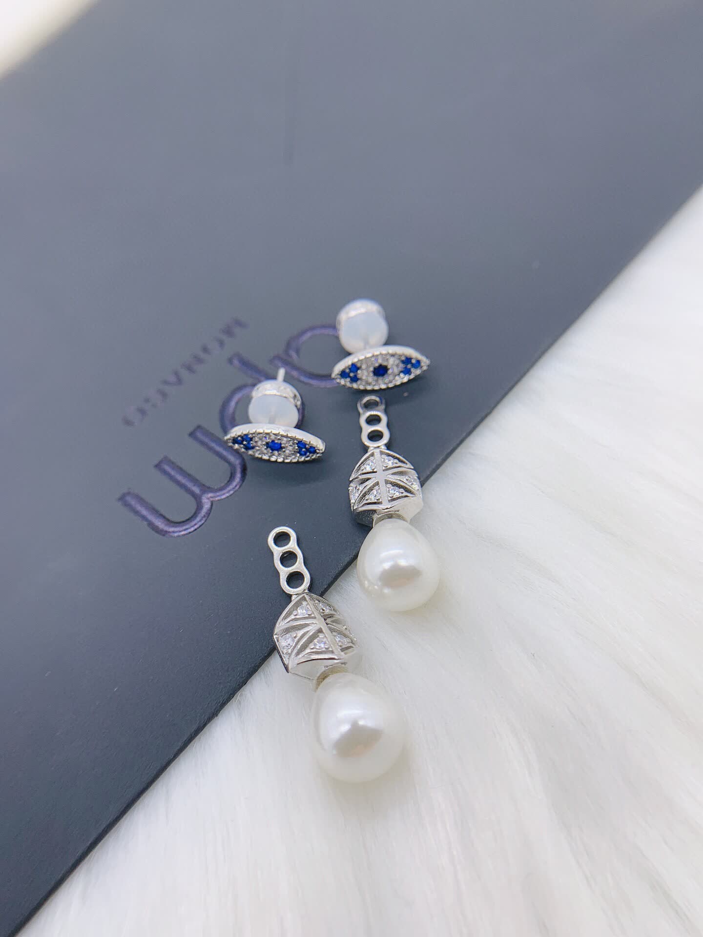 APM Monaco Elegant Pearl and Sapphire Eye Stud Earrings